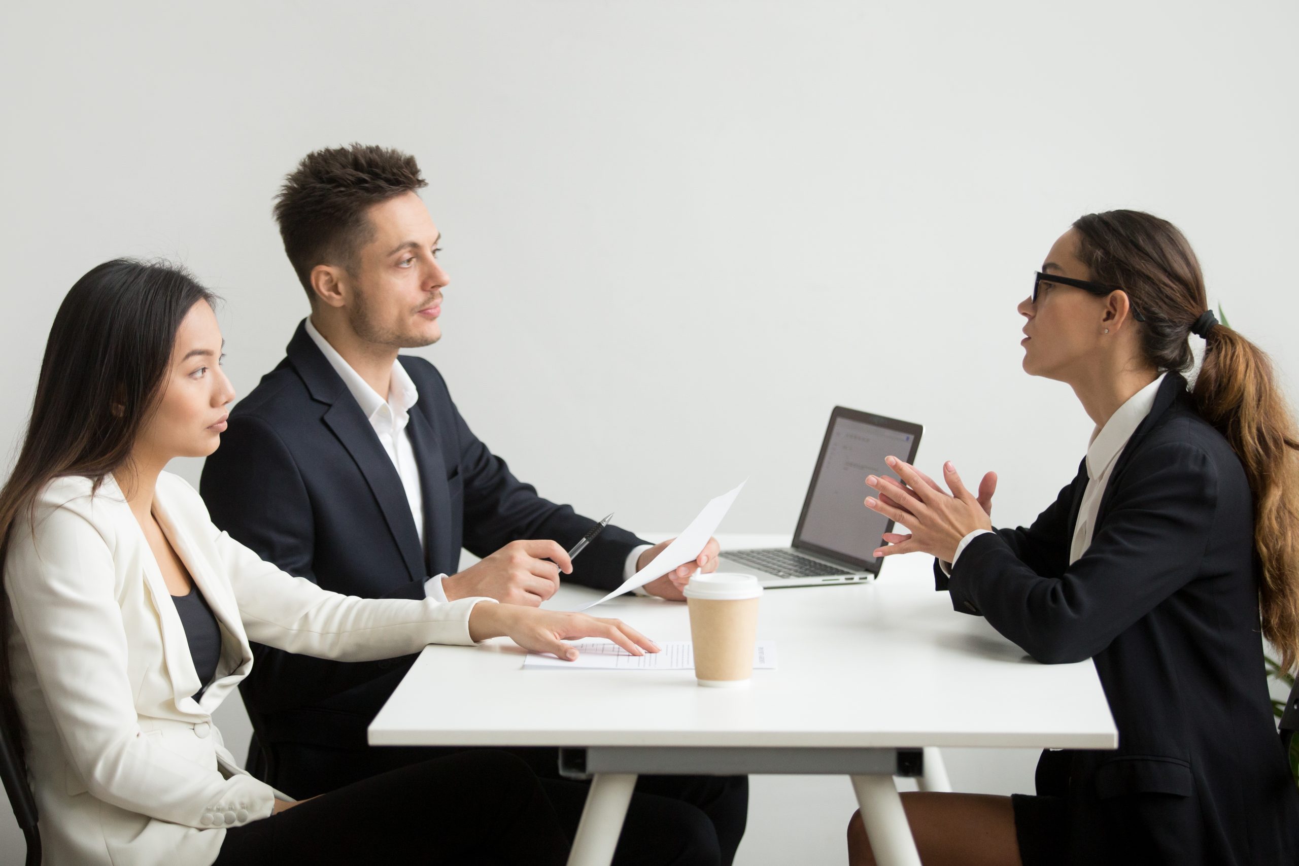 Young professional tackling Python interview questions in a formal interview setting.